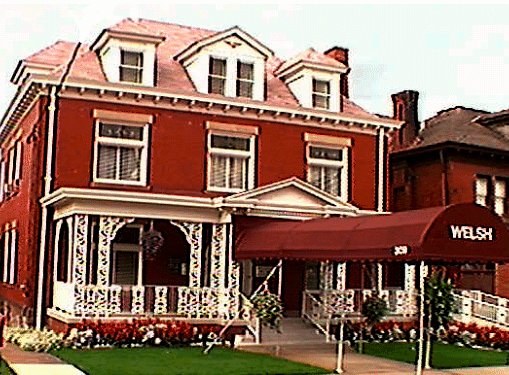 A group of people are posing for a picture together and smiling.
