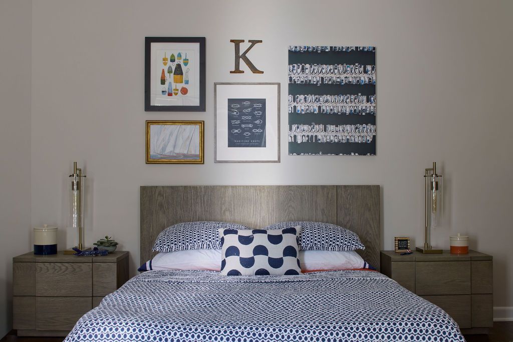 Bedroom with bed, nightstands, artwork, and neutral color scheme.