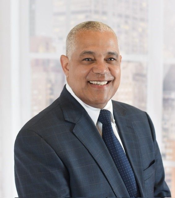 A man in a suit and tie is smiling for the camera | Selwyn Hicks