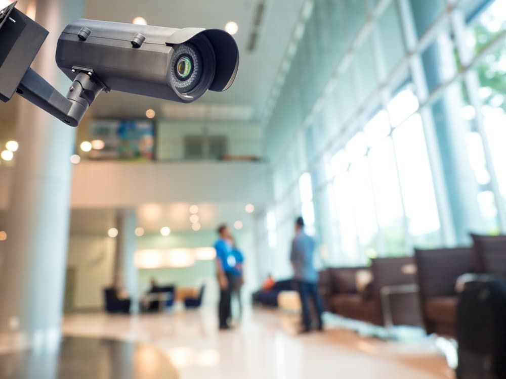 A Security Camera is Hanging From the Ceiling of a Building — BNCC Security Services in Port Macquarie, NSW
