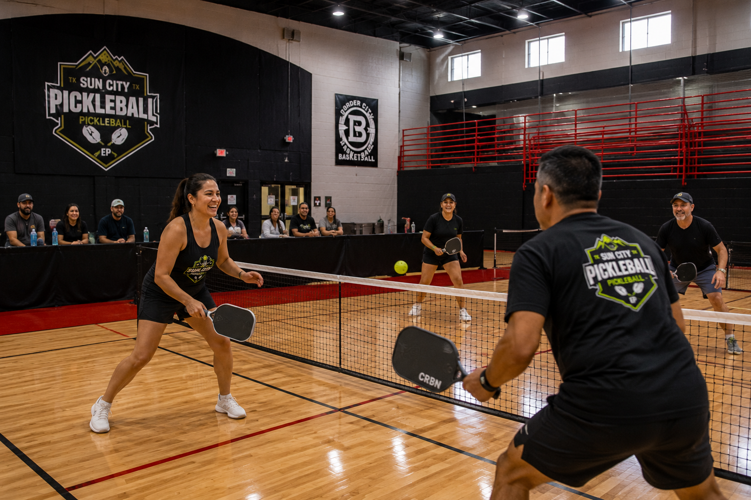Compete in a friendly doubles match at Sun City Pickleball Club as spectators watch courtside