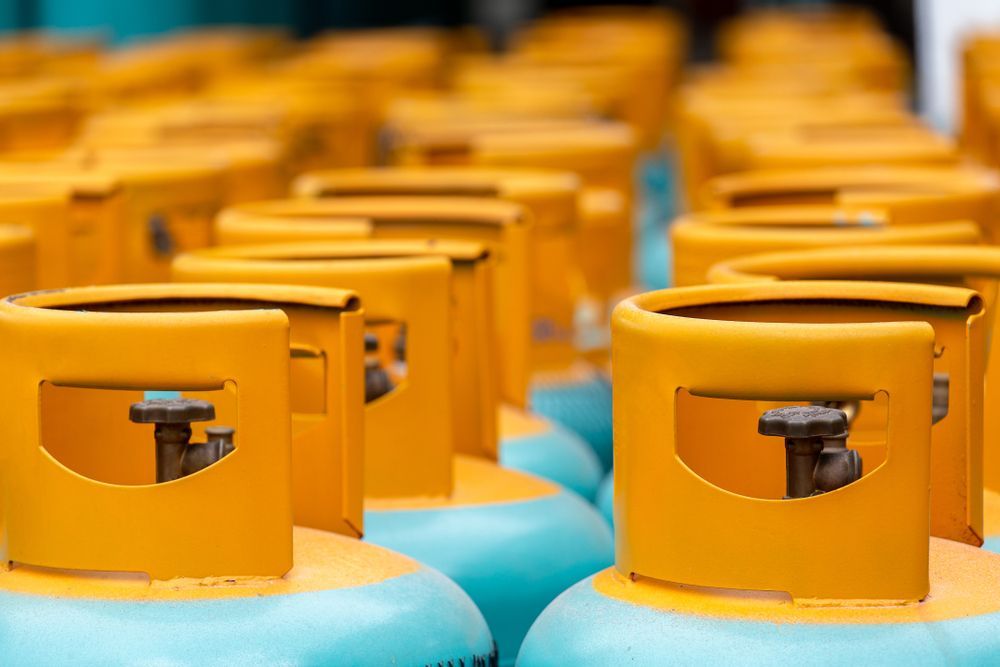Yellow Propane Tanks, Lined Up, with Blue Bases — Lakeside Gas Fridges In Maitland, NSW