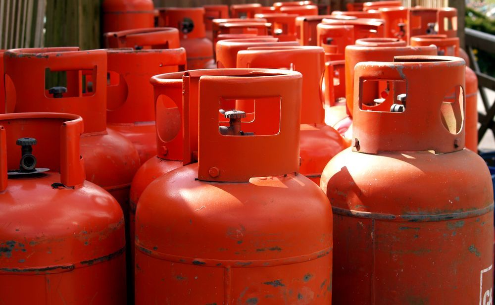 Red Propane Gas Cylinders, Outdoors — Lakeside Gas Fridges In Argenton, NSW
