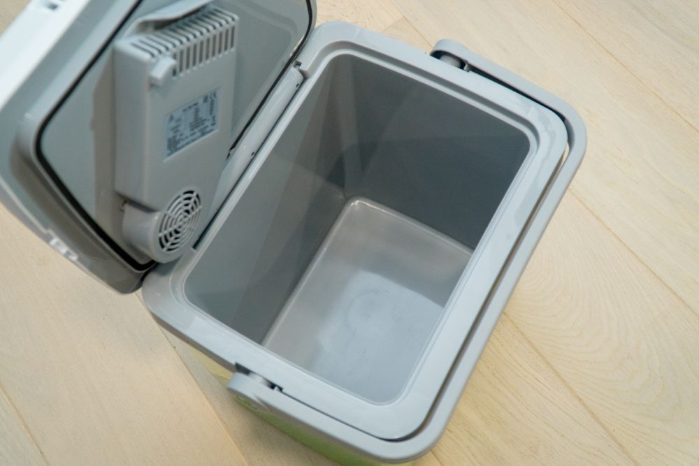 Open, Empty Portable Cooler with Internal Cooling Unit, on A Wood Floor — Lakeside Gas Fridges In Cessnock, NSW