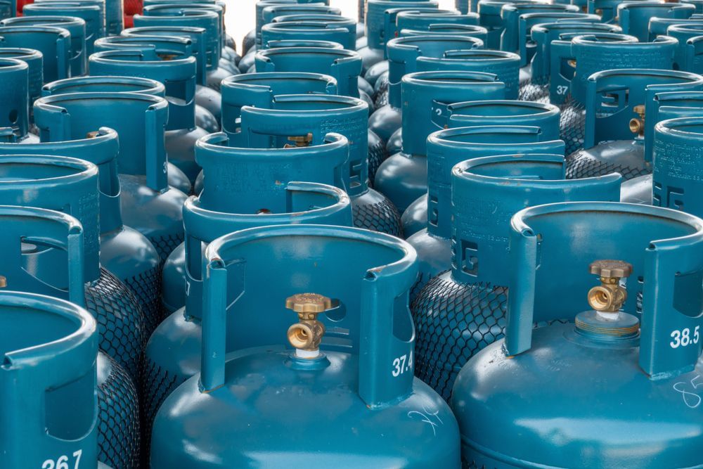 Rows of Blue Propane Tanks with Brass Valves — Lakeside Gas Fridges In Lake Macquarie, NSW