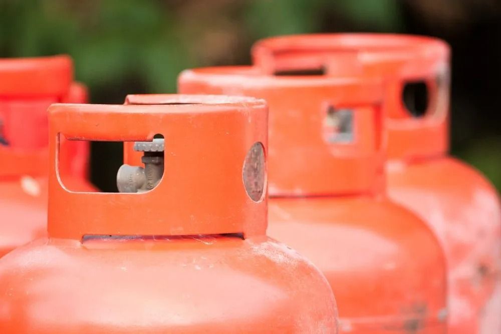 Orange Propane Tanks Lined up Outdoors — Lakeside Gas Fridges In Maitland, NSW
