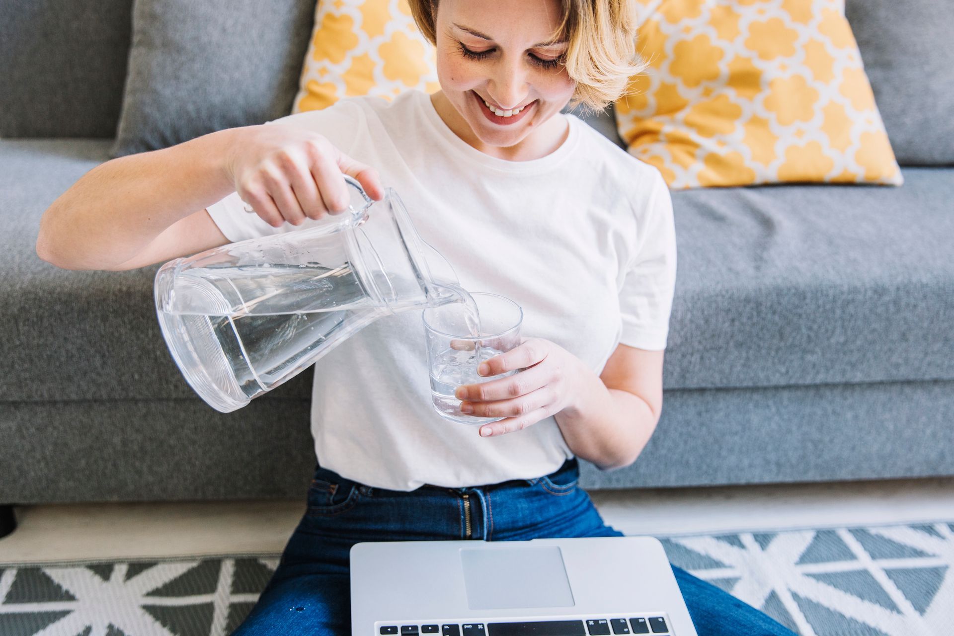 smiling woman water laptop