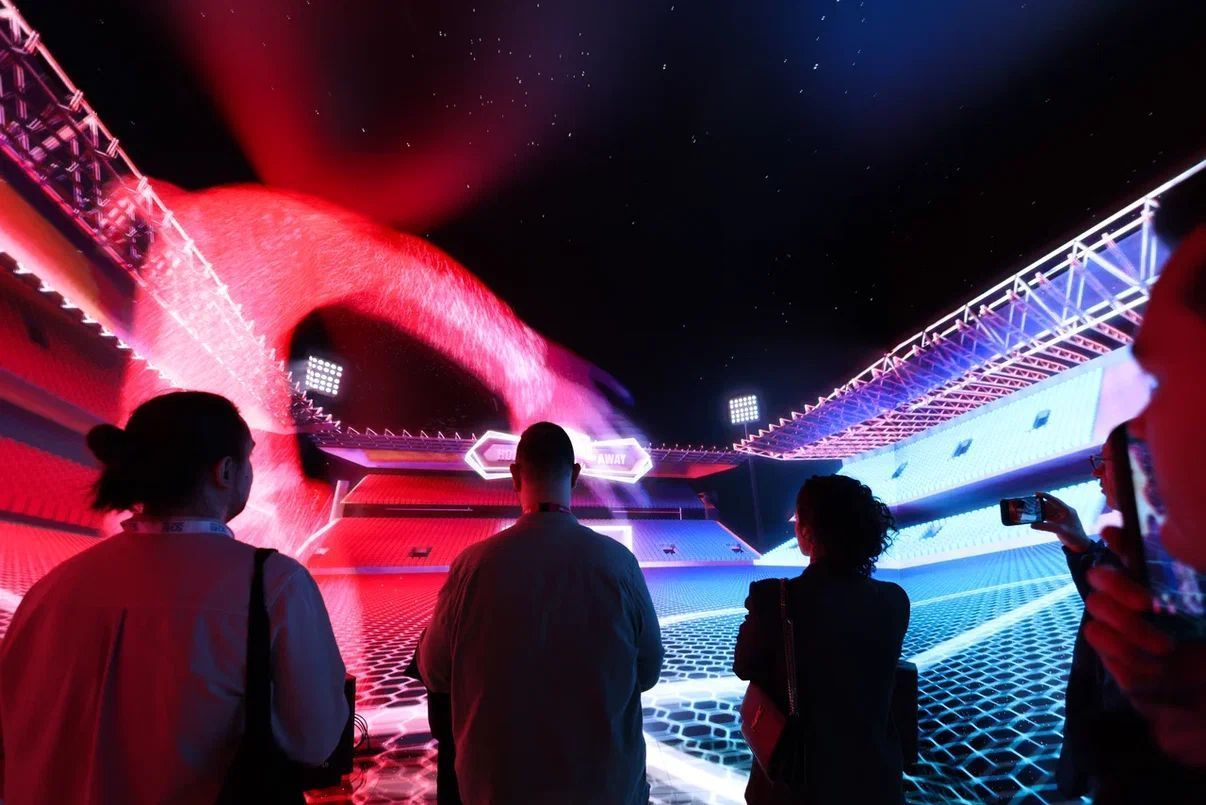 Viewers enjoy a 360 video in the immersive cube experience on an Evolve stand
