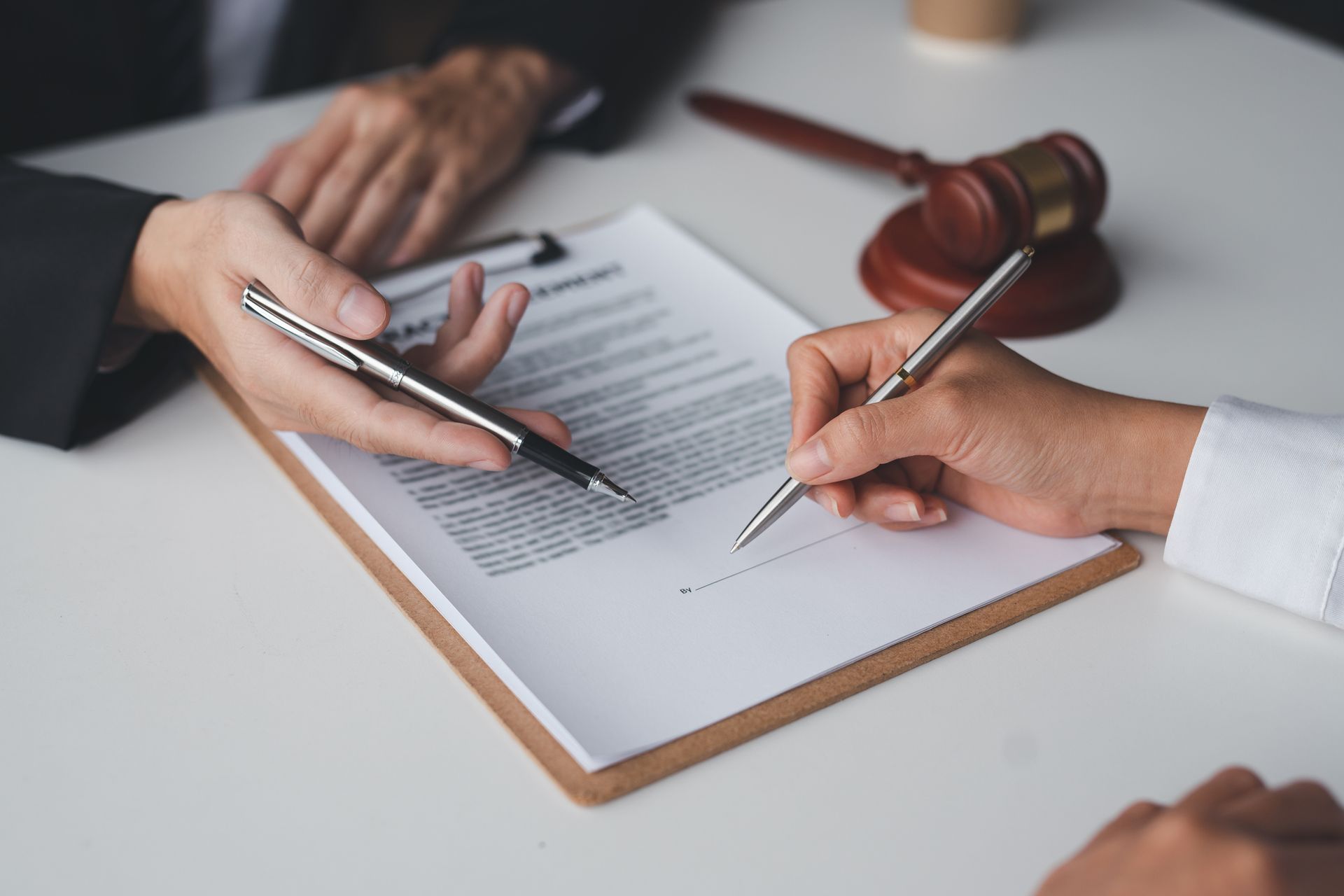 Businessman and lawyer discuss and advice on contract documents.