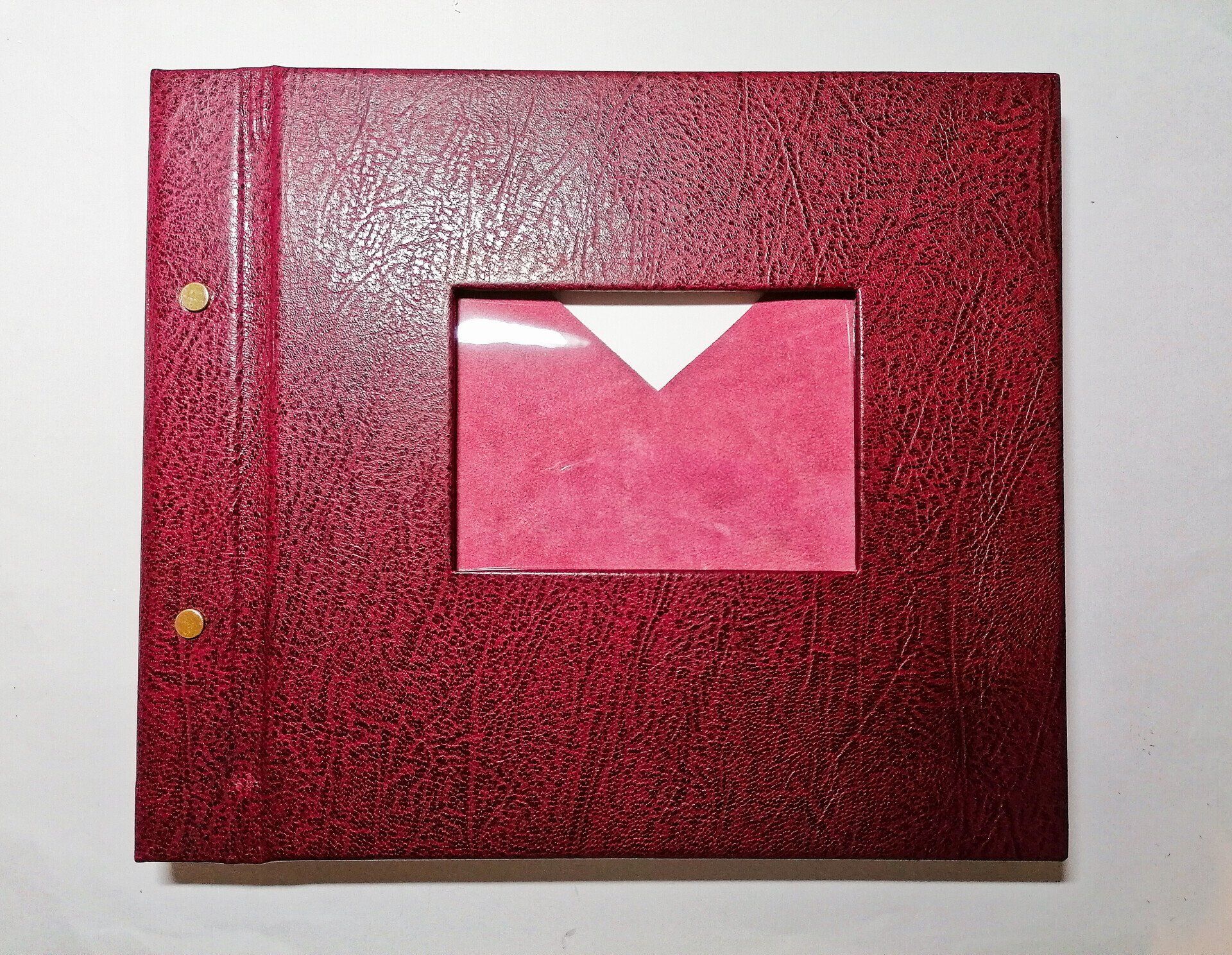The image shows a bespoke custom handmade large leather Memory Book in maroon colour, with photo window.