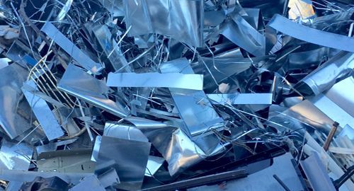 A pile of scrap metal is sitting on the ground.