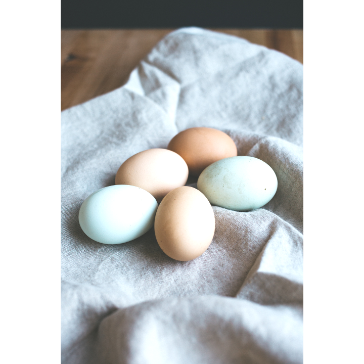 A bunch of eggs on a cloth on a table