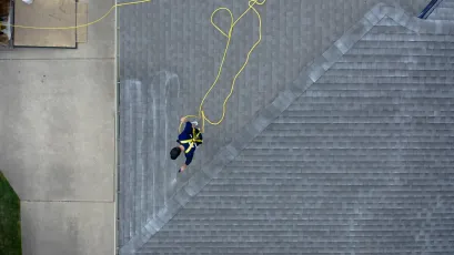 An aerial view of a man standing on top of a roof.