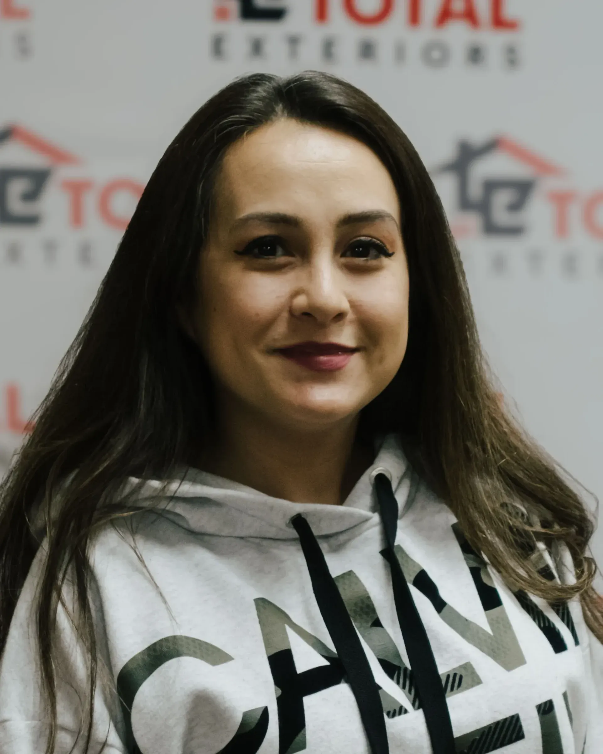 A woman wearing a hoodie with the word chanel on it