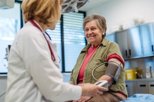 An Elderly Lady getting her blood pressure checked at her doctor's appointment