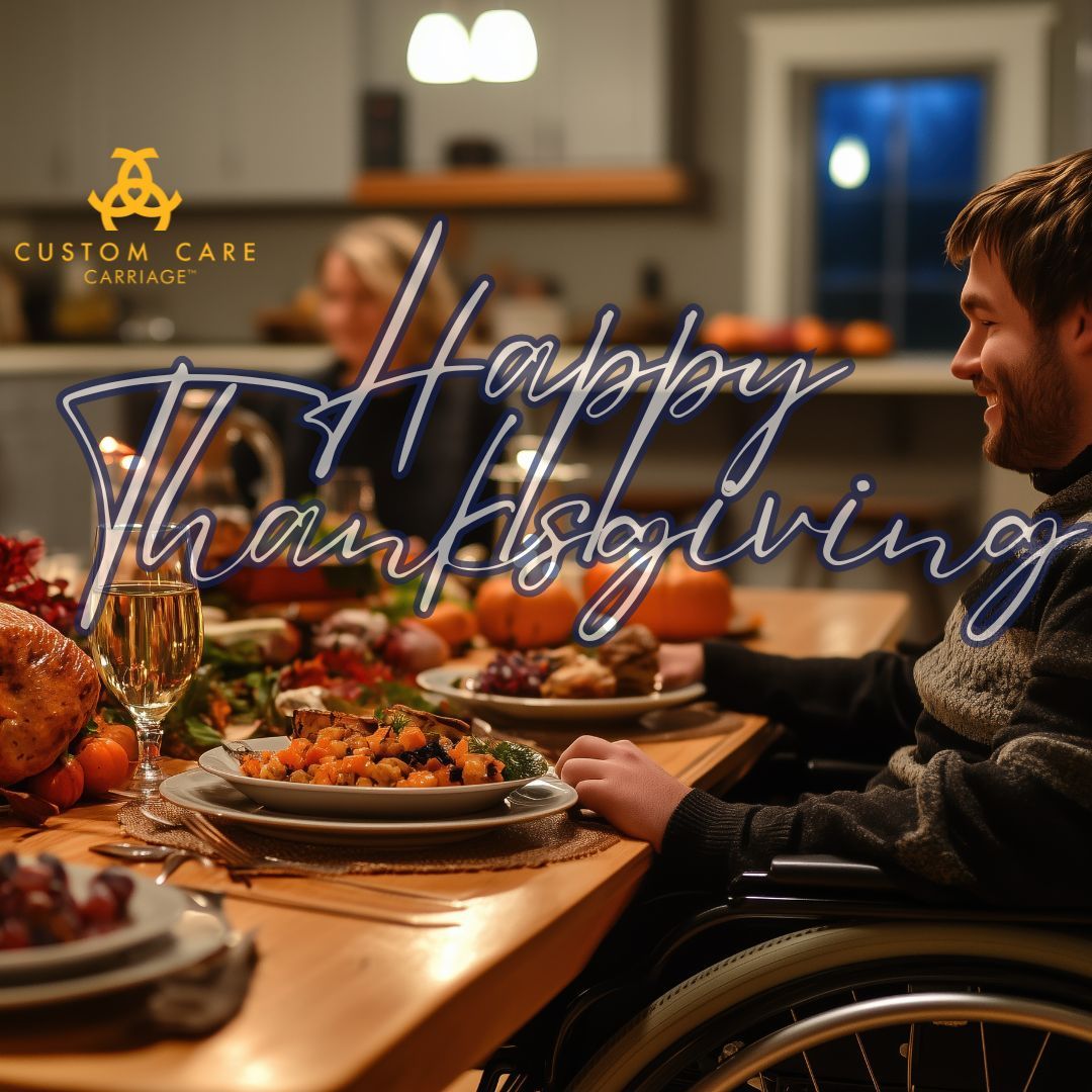 A man sitting in front of a Thanksgiving spread of food smilig