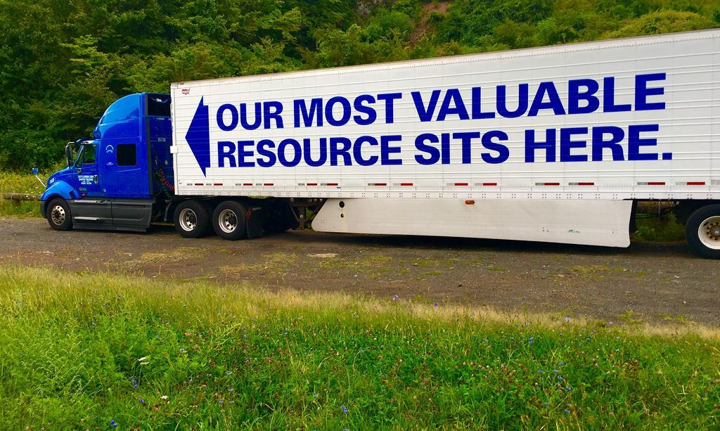 Blue semi-truck trailer with the words