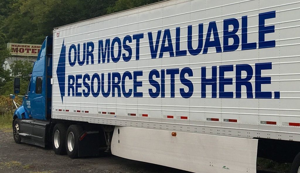 Blue and white semi-truck with text