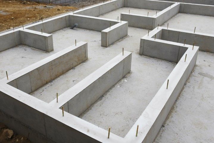 Concrete foundation walls laid out for a house on a construction site