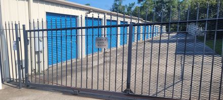 An empty storage room with a garage door open.