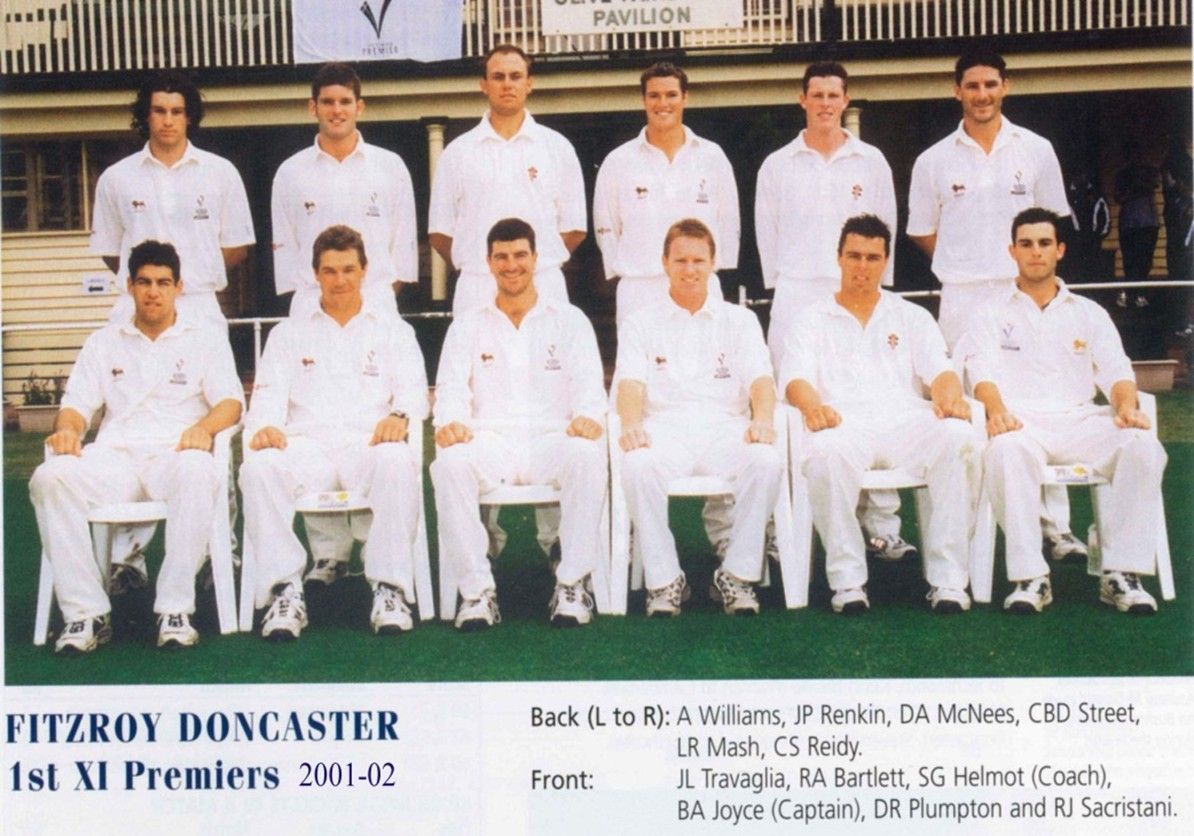Fitzroy Doncaster 1st XI Premier 2001-02 cricket team posed in white uniforms with trophy and team sign