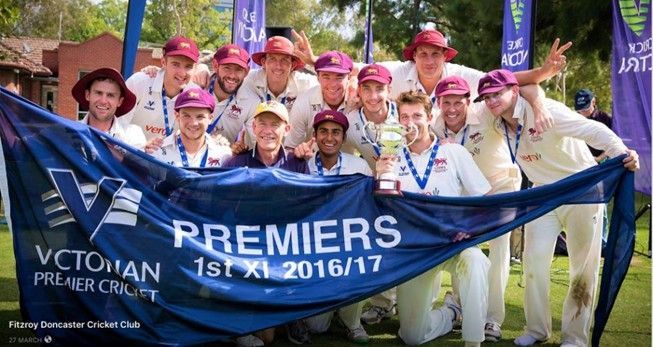 Cricket team holding a blue “Premiers” banner, celebrating a 1st XI 2016/17 win.