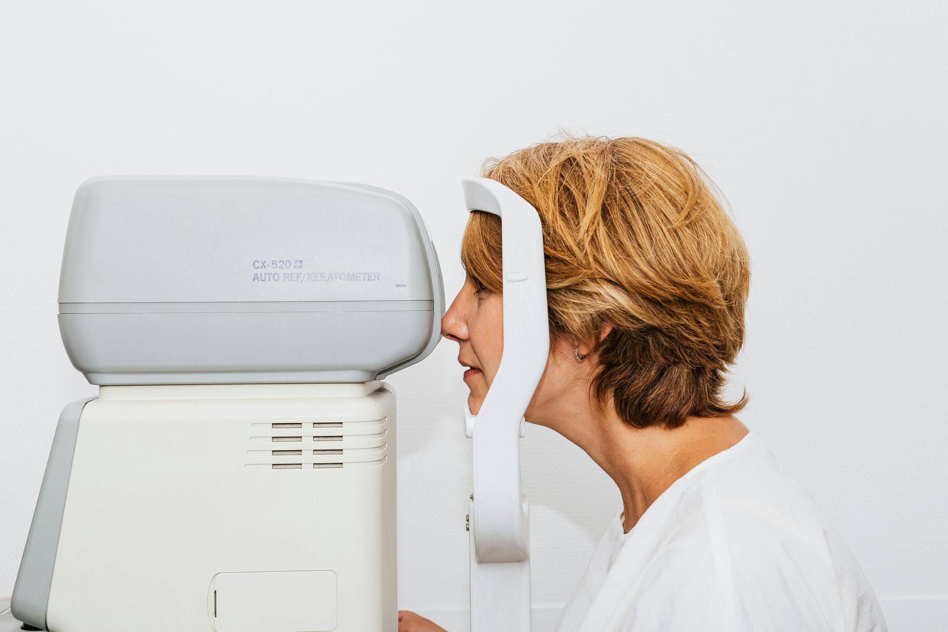 A woman is getting her eyes checked by an ophthalmologist.