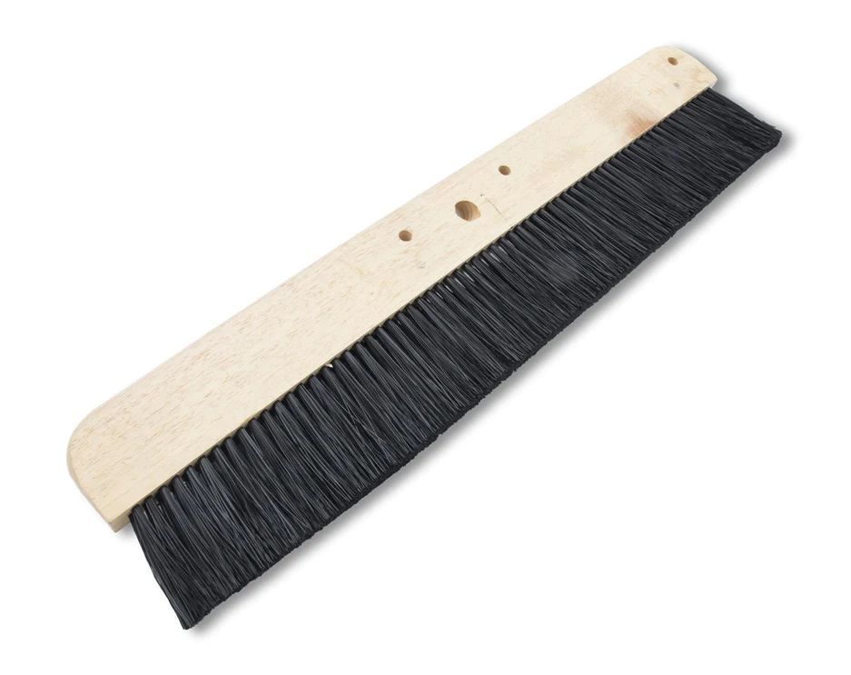 Concrete finishing broom with wood block and stiff bristles for creating non-slip textures.