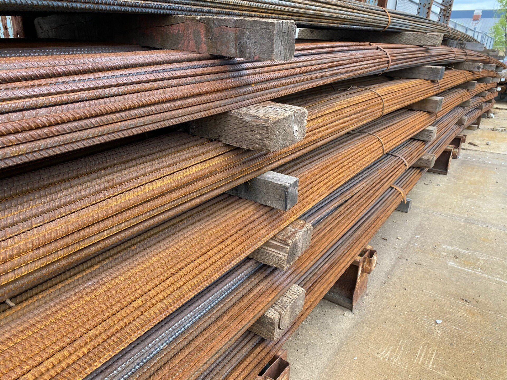 Stacked steel rebar bundles stored on racks for concrete reinforcement and construction projects