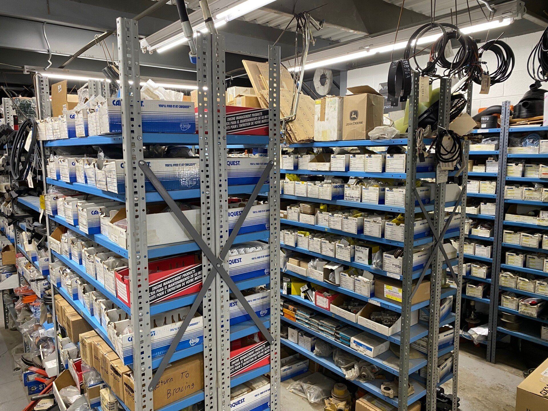 Warehouse shelves stocked with concrete and masonry equipment parts and supplies at Bracing Systems facility