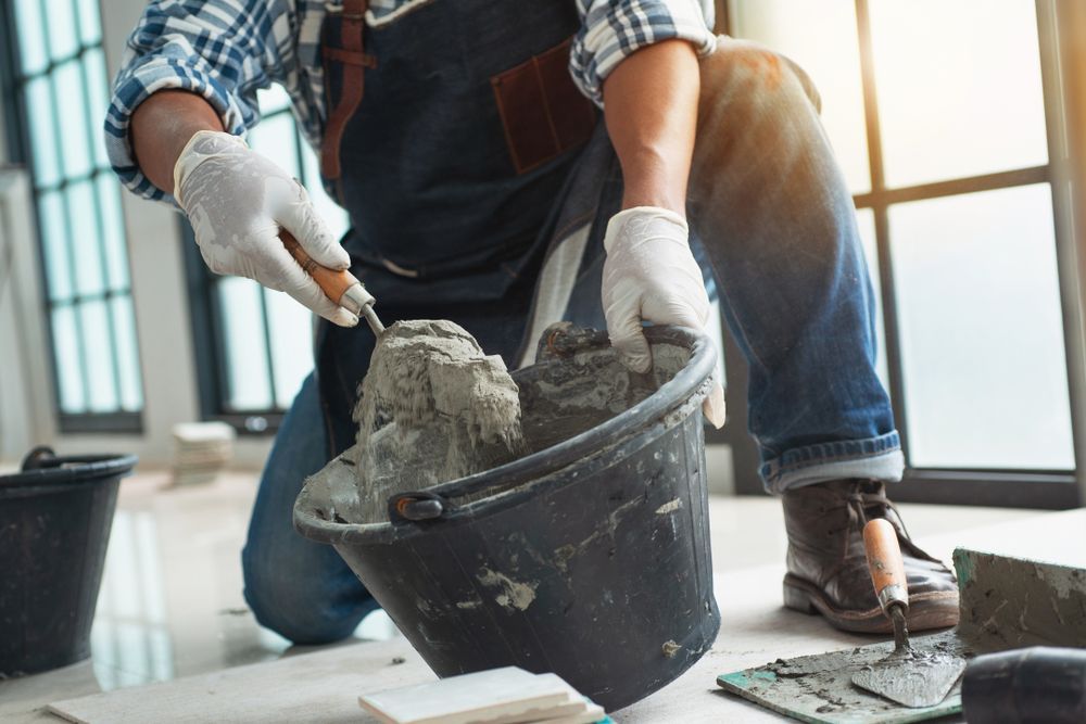 Construction worker mixing concrete