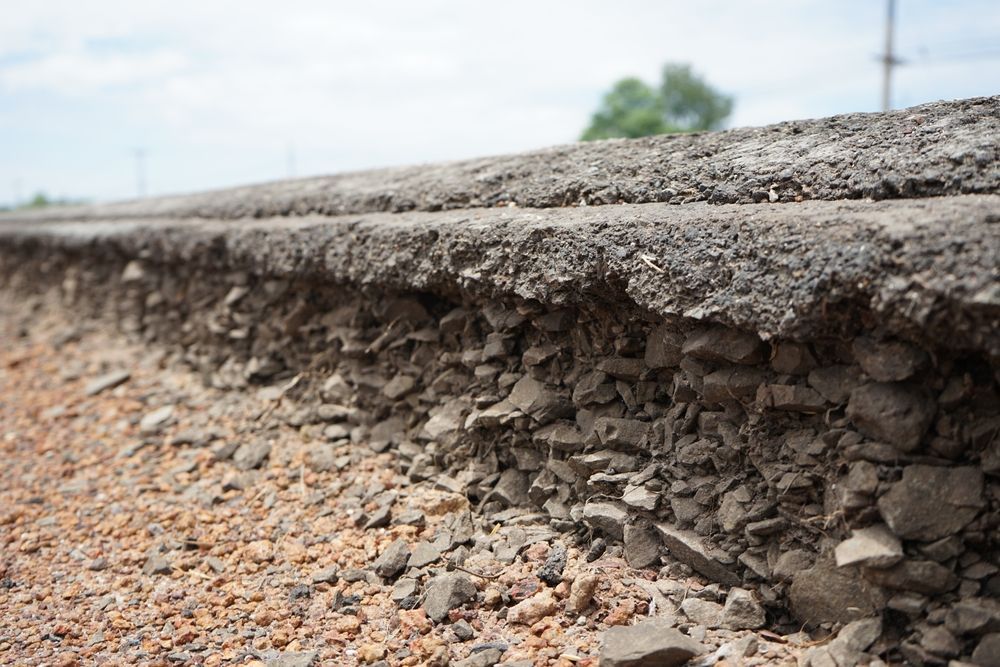 A close up of a road with road base underneath.