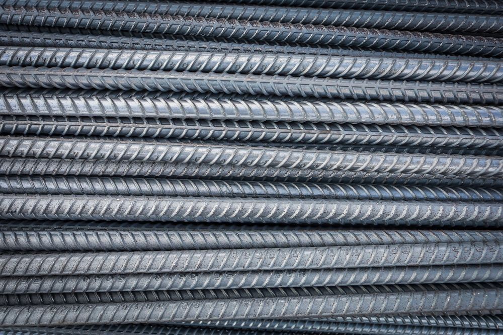 Stacked steel rebar rods used for concrete reinforcement in construction projects