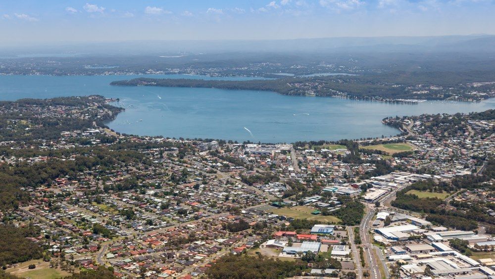 Aerial View Of A Town Bordering A Large Body Of Water — Refrigeration & Air Conditioning in Warners Bay, NSW