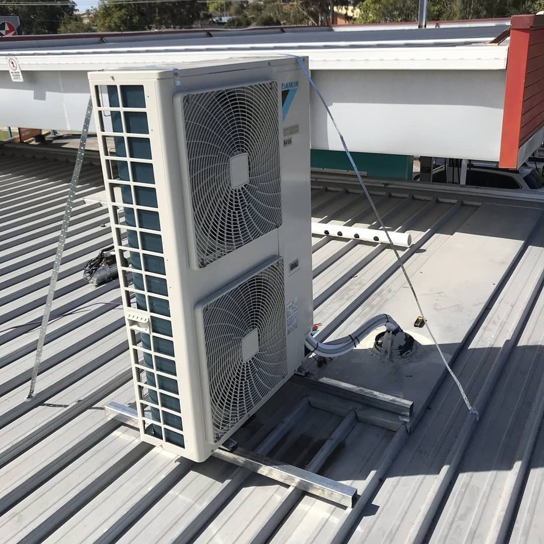 Air Conditioning Unit on A Corrugated Metal Roof, Supported by Metal Brackets — Refrigeration & Air Conditioning in Hunter Valley, NSW