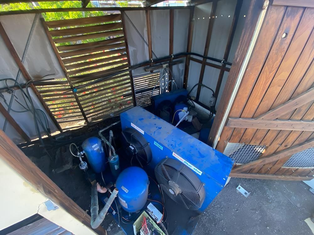Blue Machinery With Fans, Inside a Wooden Shed — Refrigeration & Air Conditioning in Newcastle, NSW