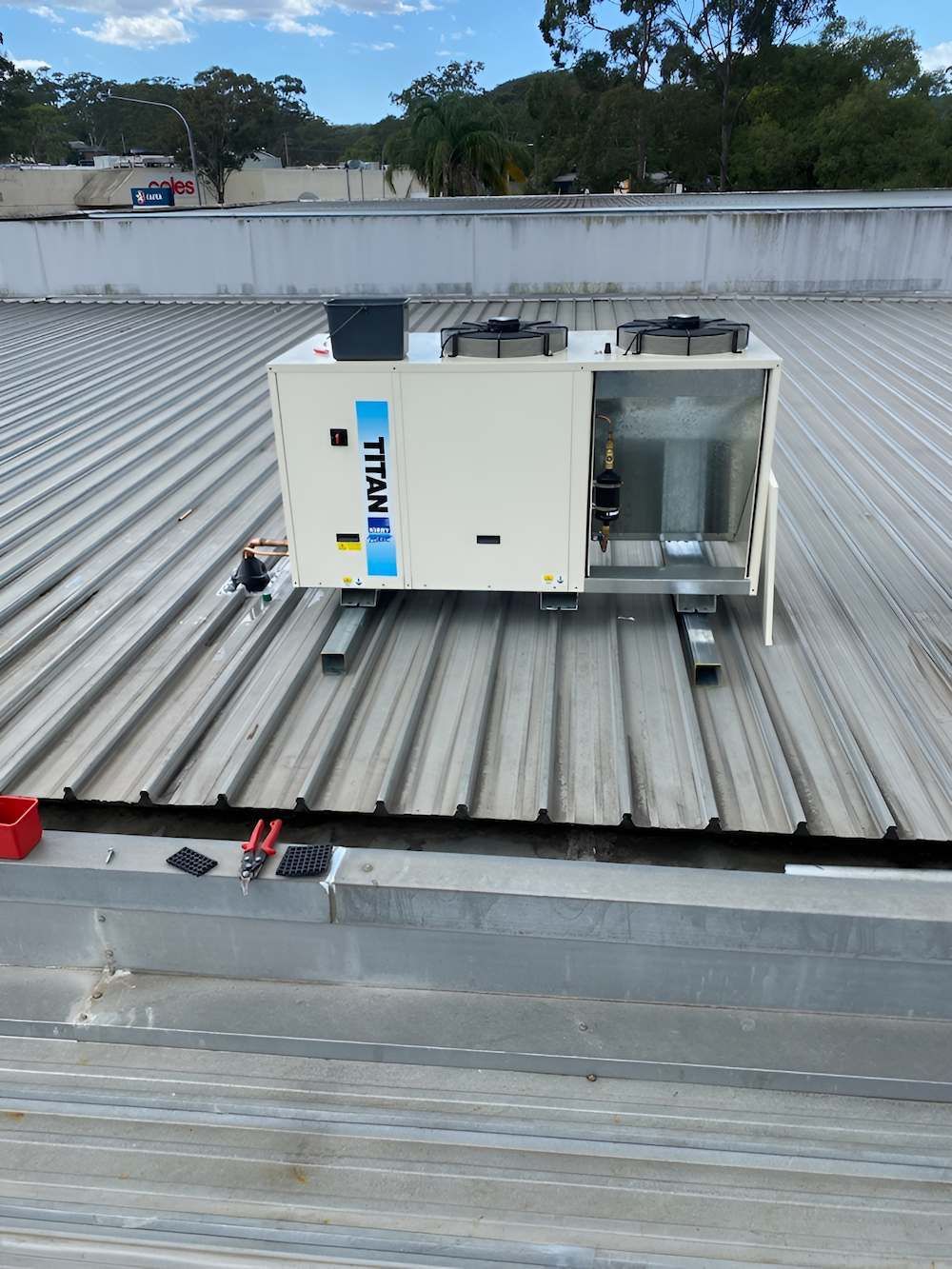 HVAC Unit on a Corrugated Metal Roof, Possibly Under Construction — Refrigeration & Air Conditioning in Warners Bay, NSW