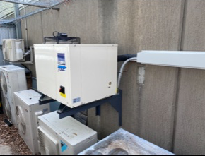 A Row Of Air Conditioners On The Side Of A Building — Refrigeration & Air Conditioning in Jewells, NSW
