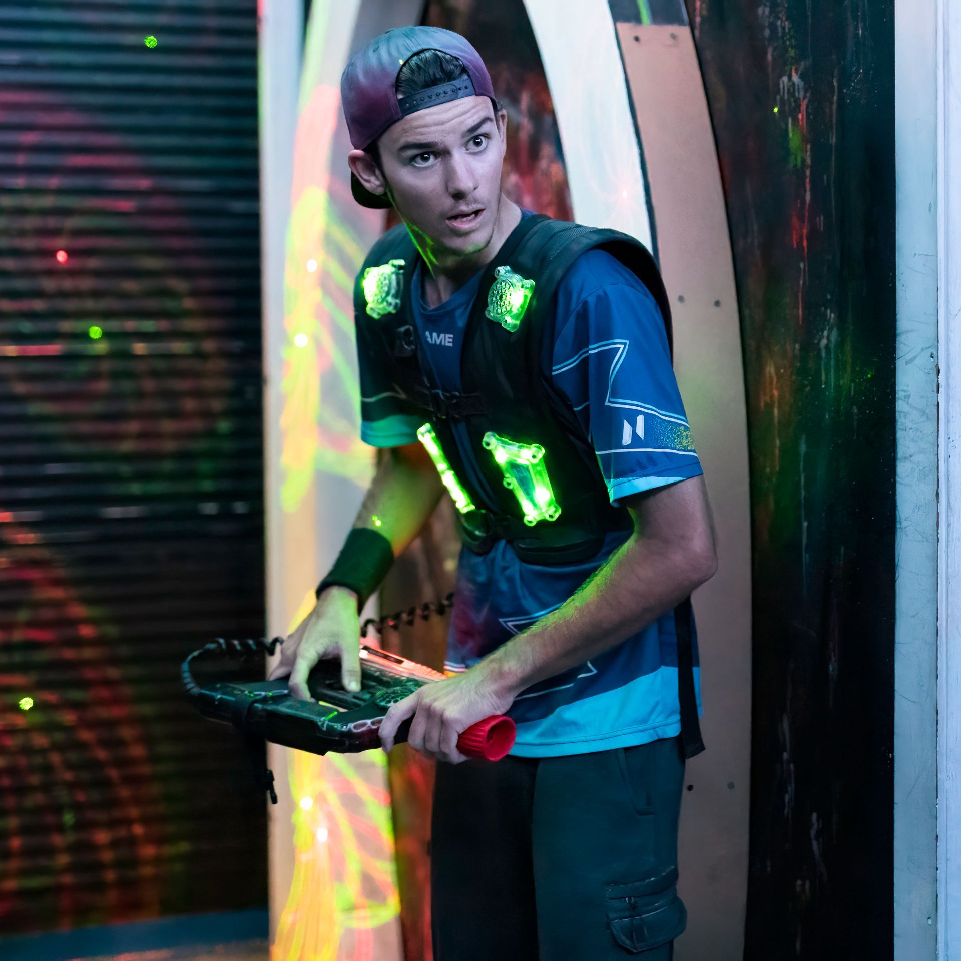 Young adult plays competitive laser tag