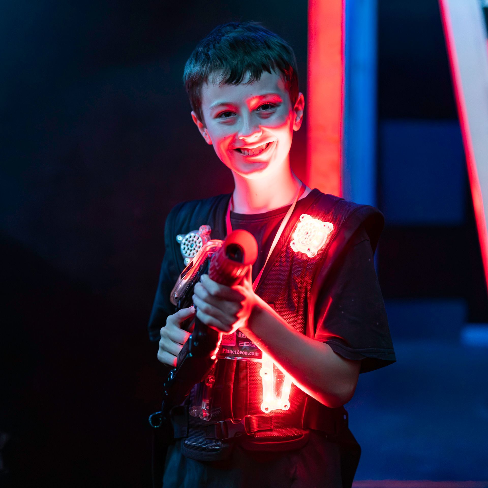 Boy plays competitive laser tag
