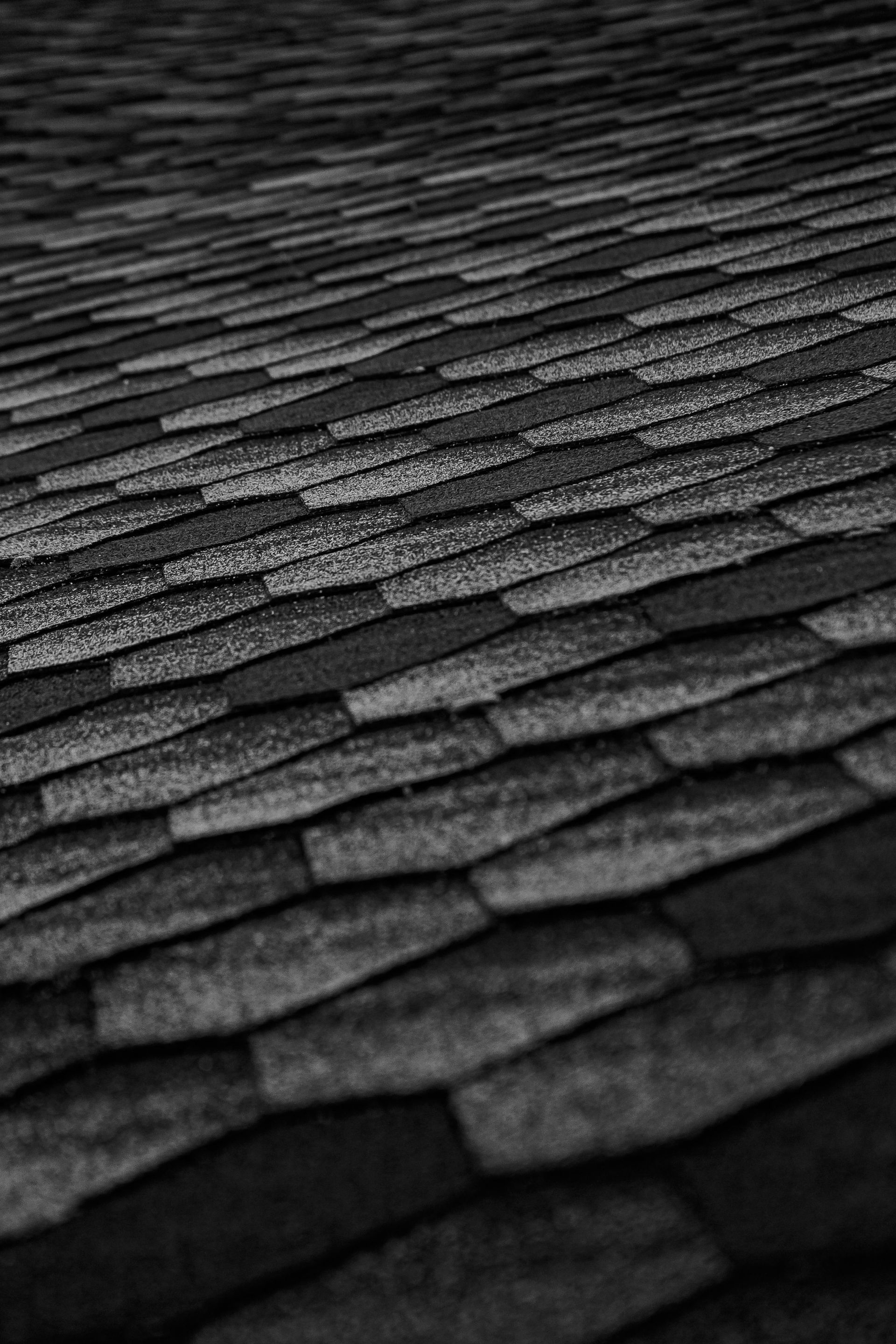 Two men are working on the roof of a house