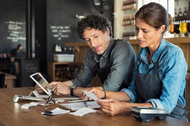 Two entrepreneurs working on their financial statements.