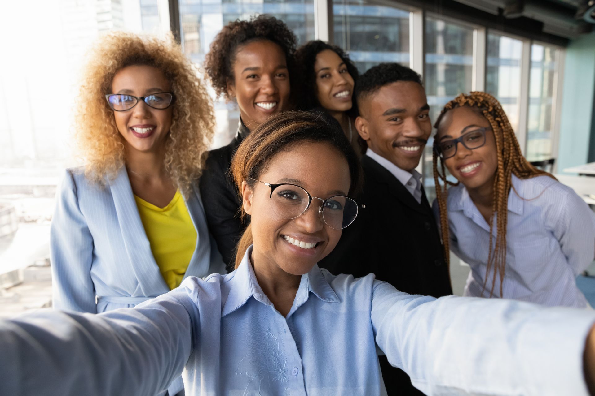 A group of business people are taking a selfie together