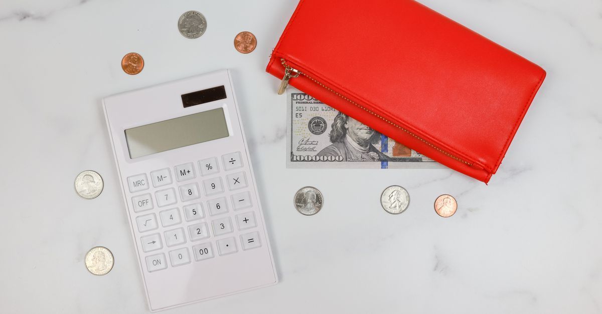 A person reviewing notes while budgeting for coaching sessions