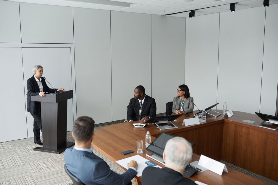 A speaker rehearsing a talk while a coach observes