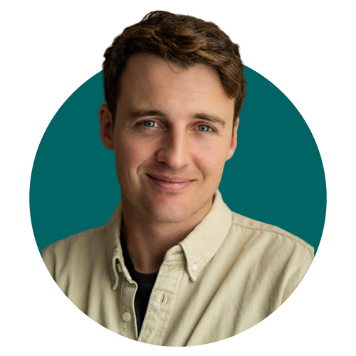 A man in a tan shirt is smiling in a circle.