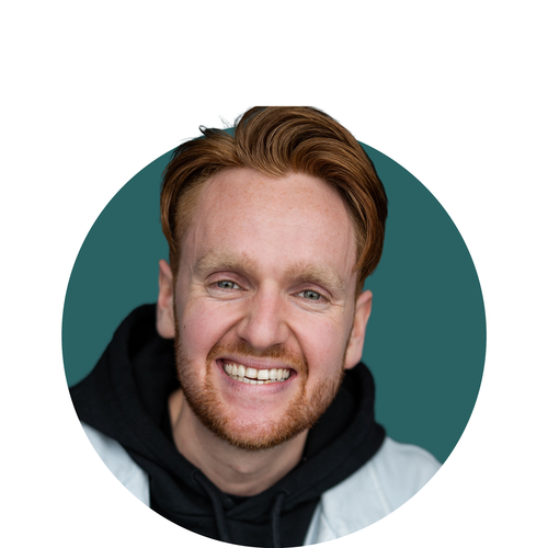 A man with red hair and glasses is smiling in a circle
