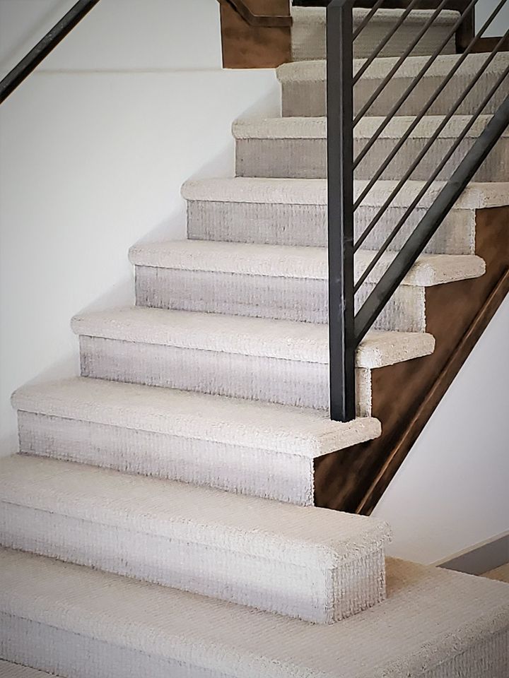 A close up of a white tiled floor in a room.