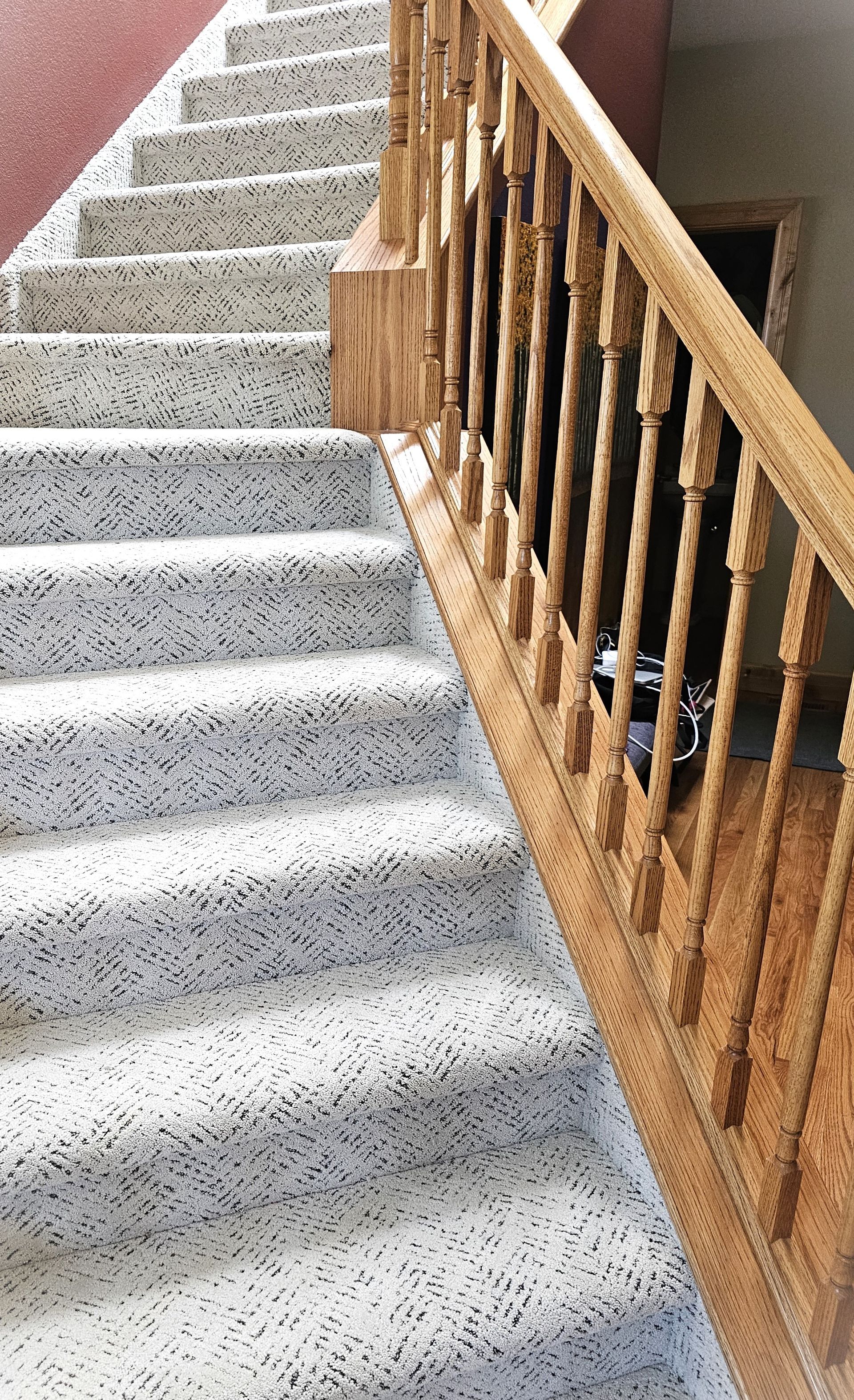 A person is installing a wooden floor with a hammer.