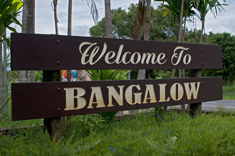 A Welcome To Bungalow Sign In The Grass — JC Coastal Construction In Bangalow, NSW